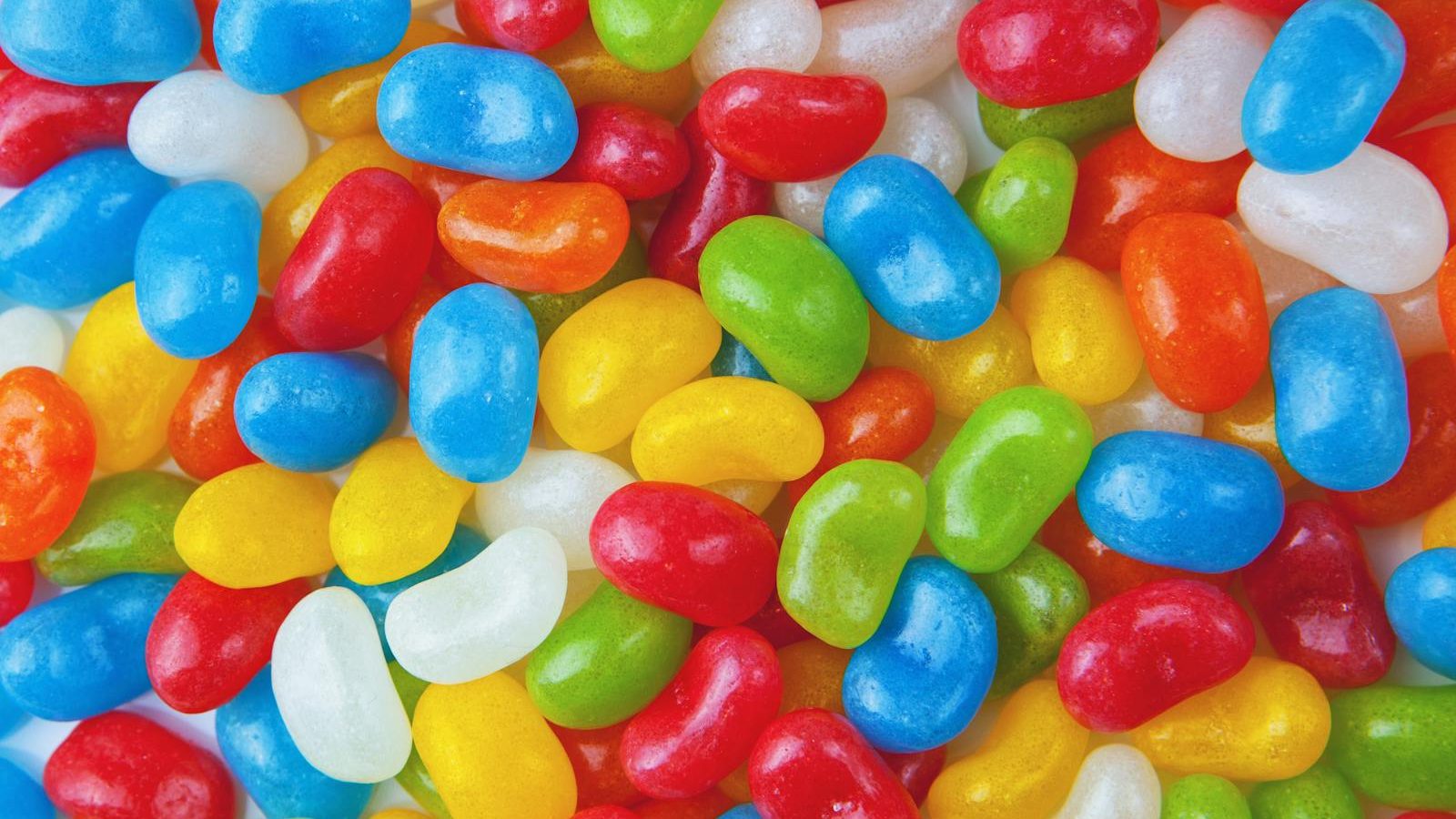 Vibrant and colorful close-up of assorted jelly beans creating a playful and sweet background.
