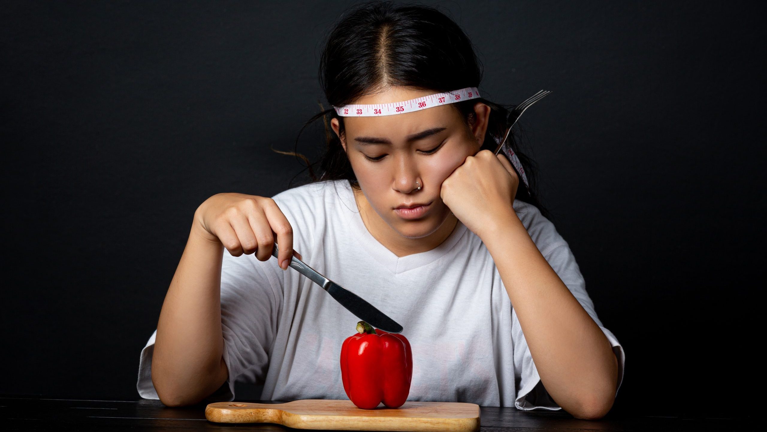 cutting calories drastically Depressed woman hungry from dieting