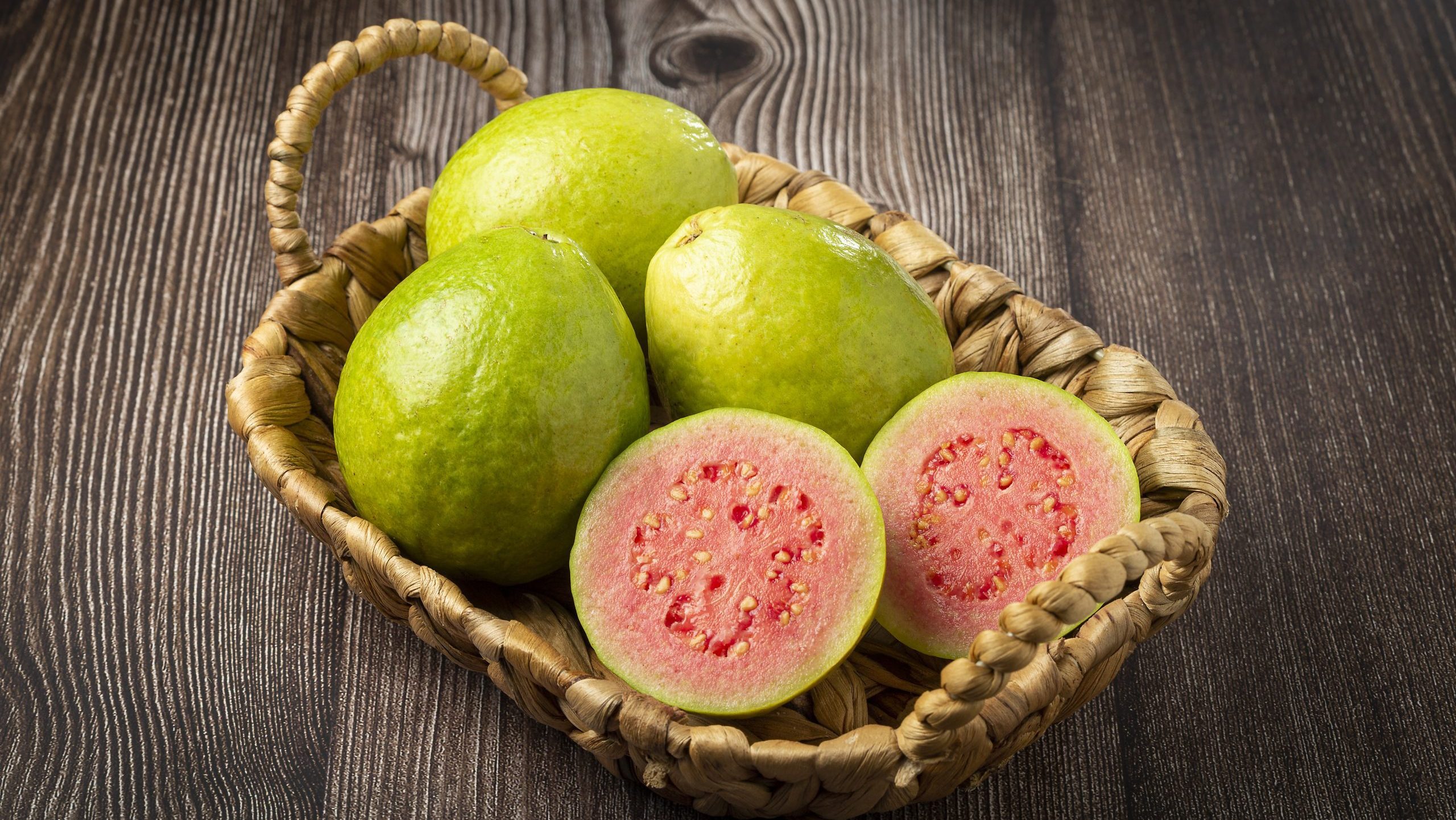 Fresh sliced ​​guavas on wooden table.