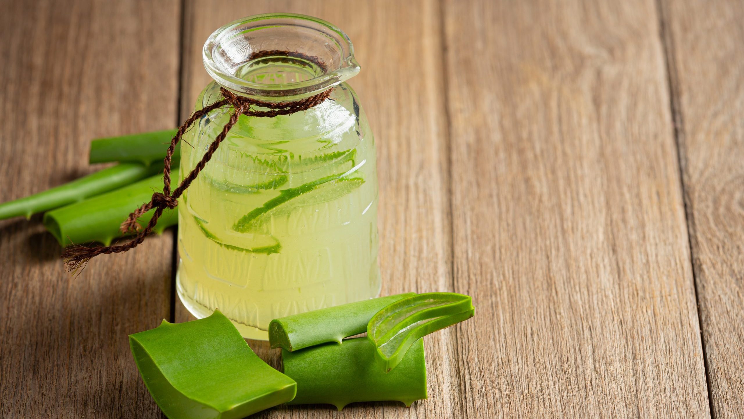 a glass of aloe vera juice put on wooden floor