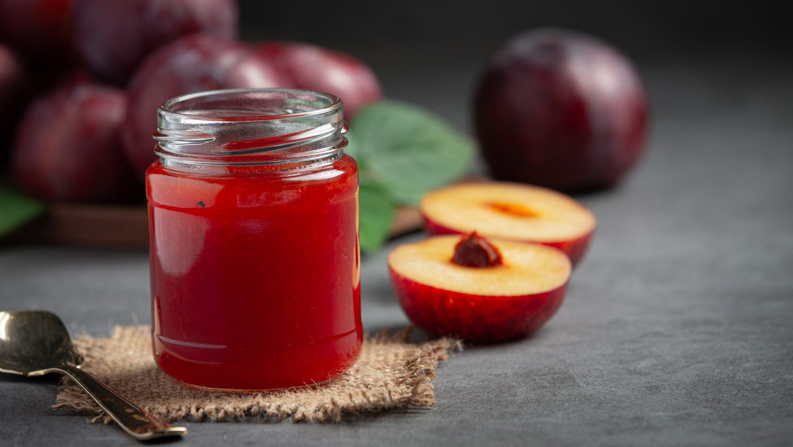 a glass of plum put on dark floor