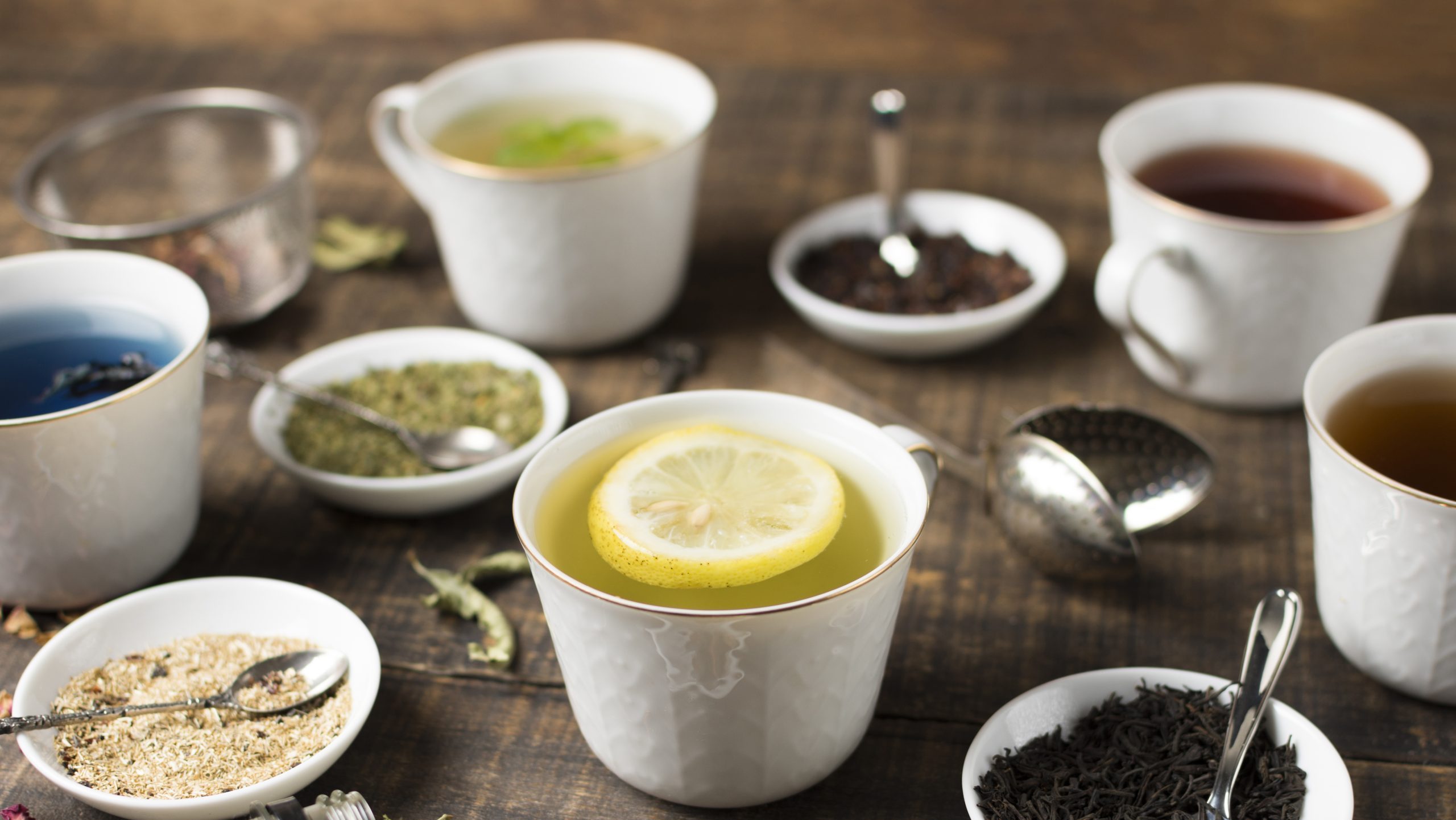 lemon-tea-different-type-herbs-wooden-table