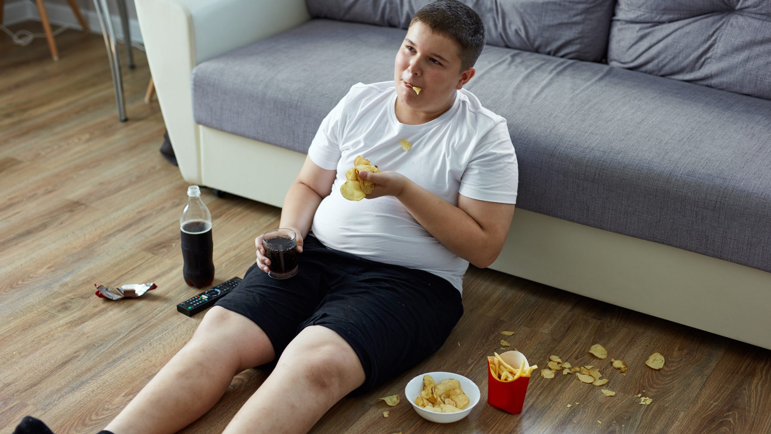 An overweight child boy enjoy leading unhealthy passive
