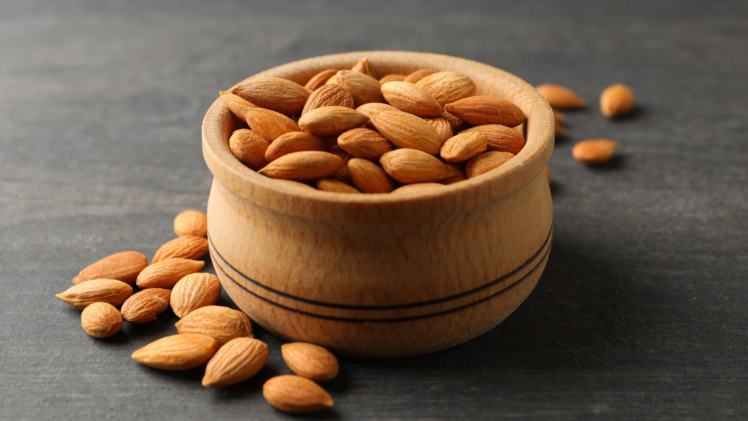 FOOD HEALTH VEGETABLE Almonds FRUITBowl,With,Tasty,Almond,On,Gray,Wooden,Background
