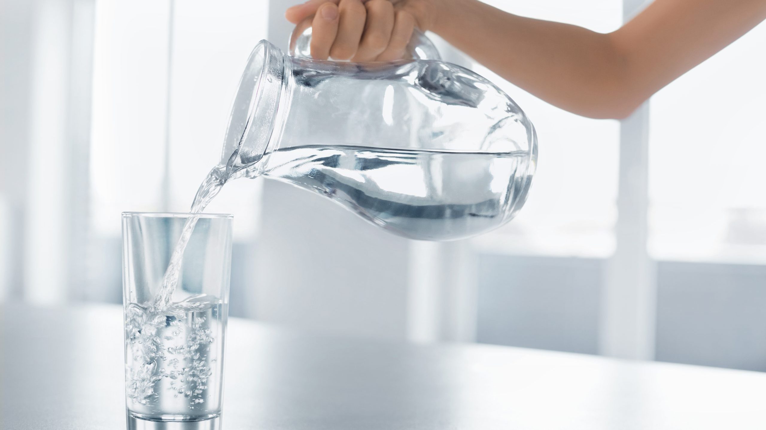 Drink,Water.,Woman's,Hand,Pouring,Fresh,Pure,Water,From,Pitcher