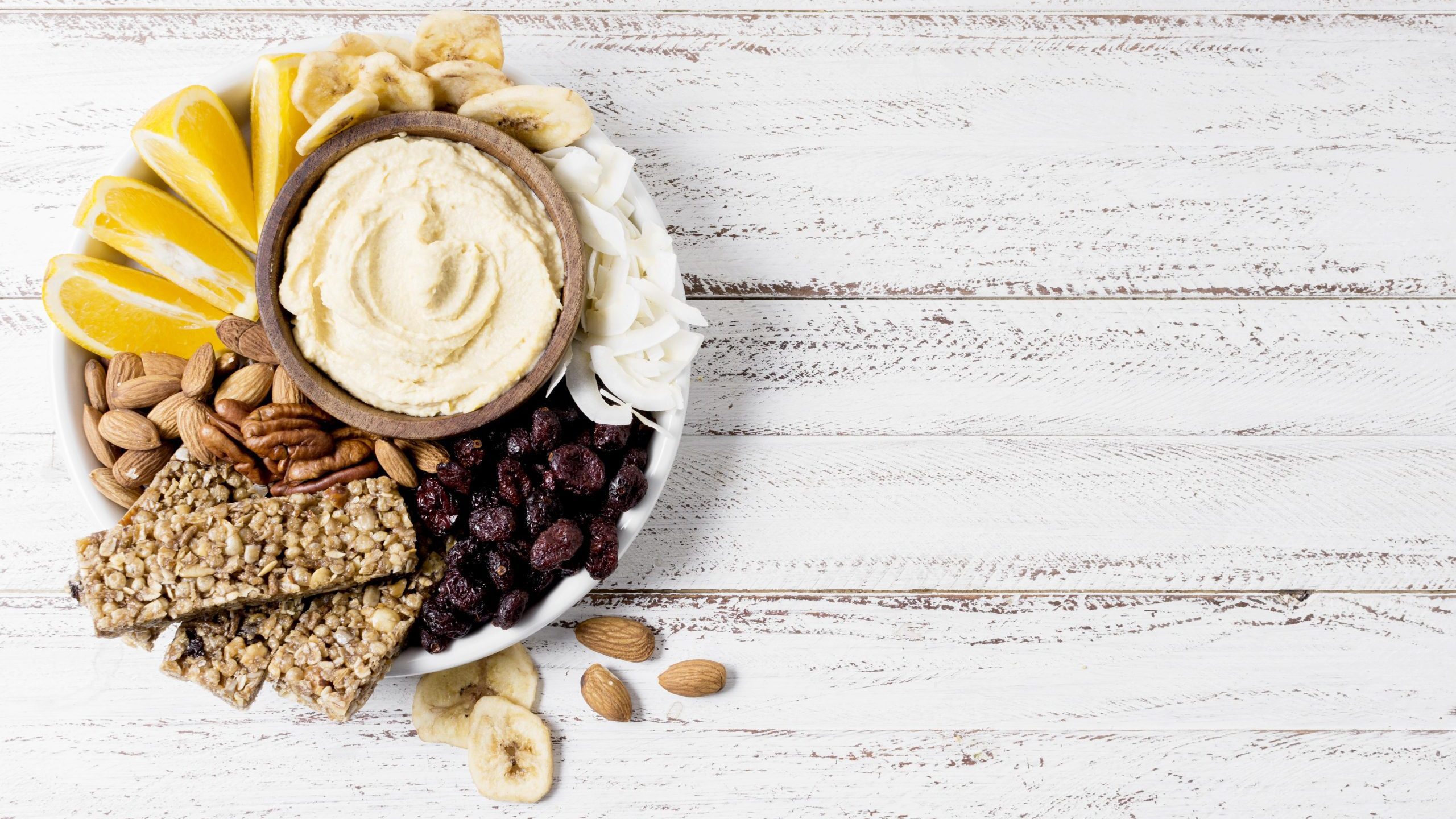 top-view-plate-with-assortment-nuts-cereal-bars-with-copy-space