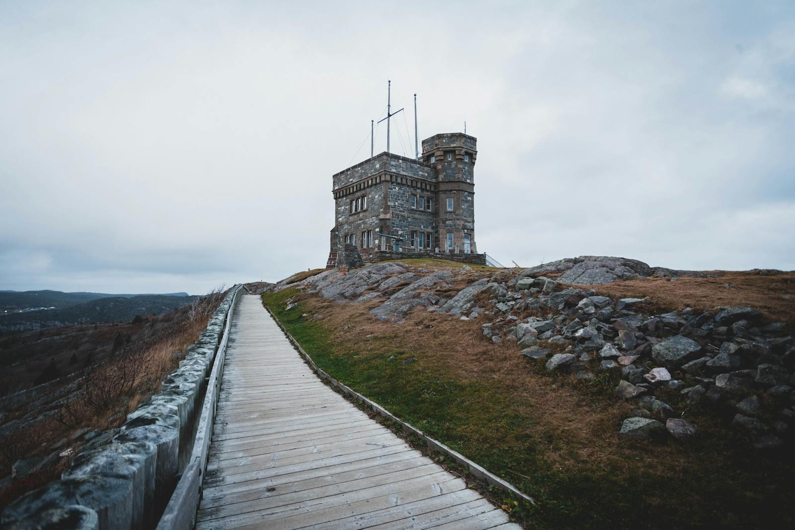 Explore the iconic Cabot Tower on Signal Hill, a historic Canadian landmark enveloped in a misty, cloudy sky.