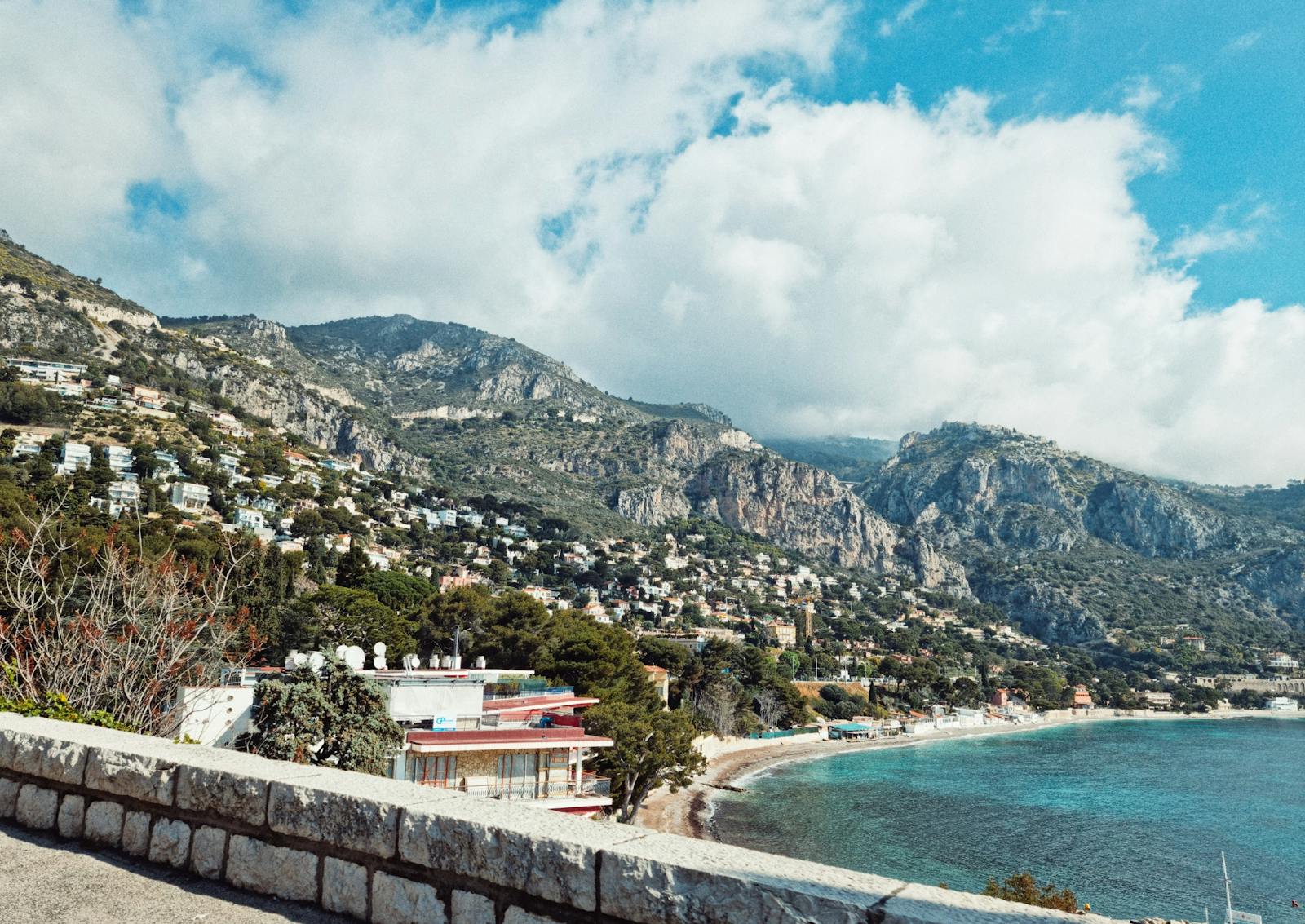 Charming Mediterranean coastal town with picturesque hills and turquoise sea views.