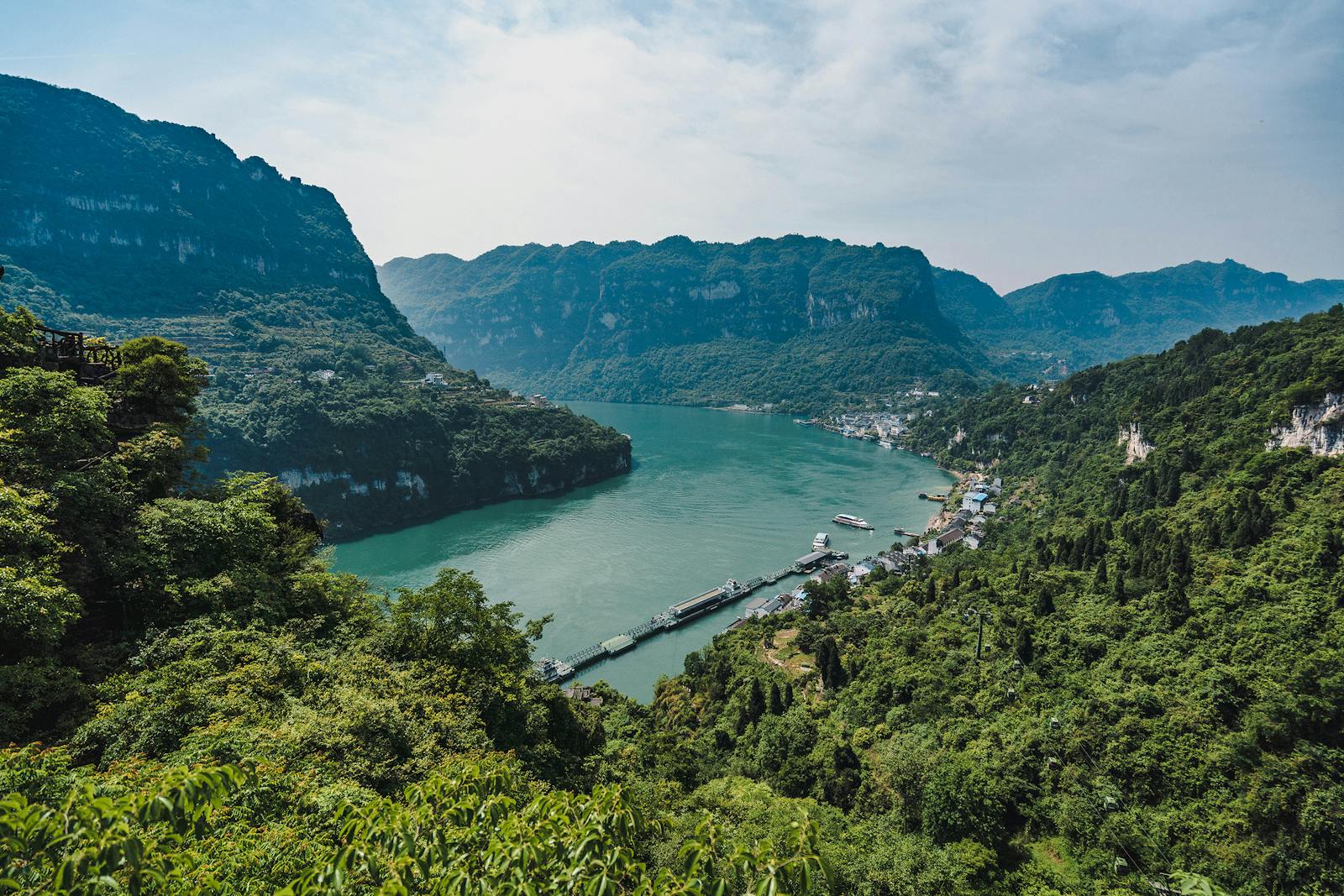 Experience the breathtaking scenery of the Yangtze River gorge with lush greenery and majestic mountains.