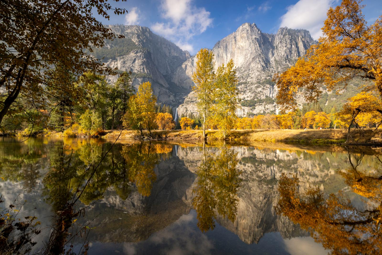 Stunning autumn view with fall foliage reflecting in the river at Yosemite National Park.