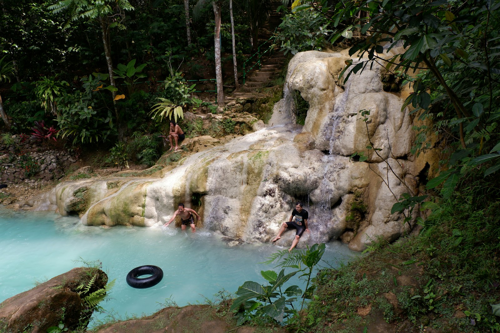 A group of people swimming in a blue pool