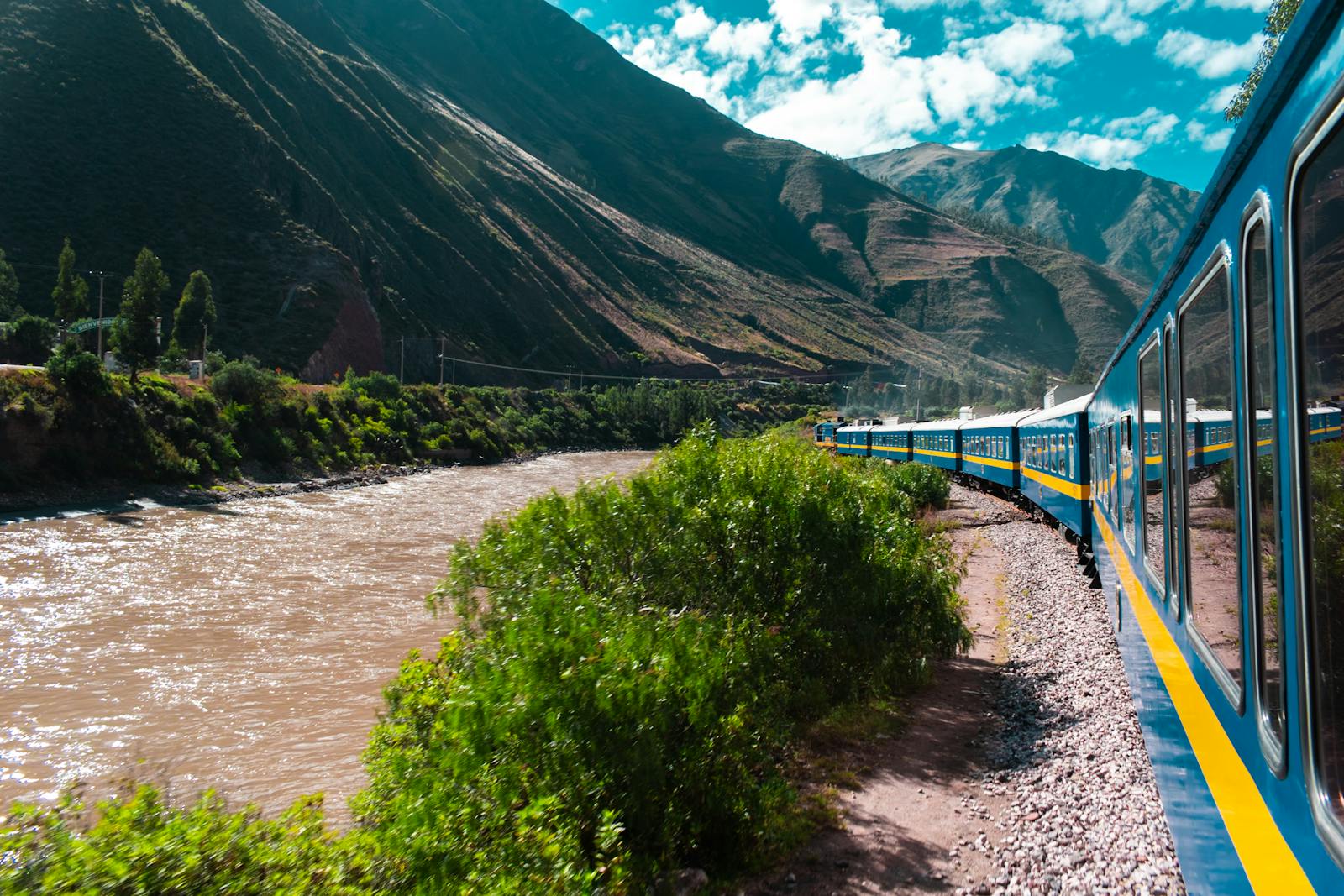Experience a vibrant train ride through the dramatic Andes landscapes near Cusco, Peru.
