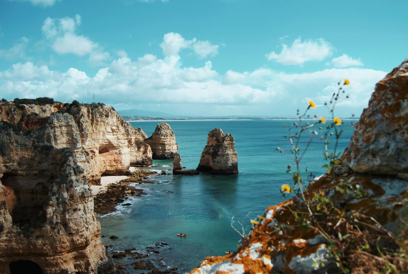 Breathtaking view of cliffs and clear turquoise ocean waters at Ponta da Piedade, Lagos, Portugal.