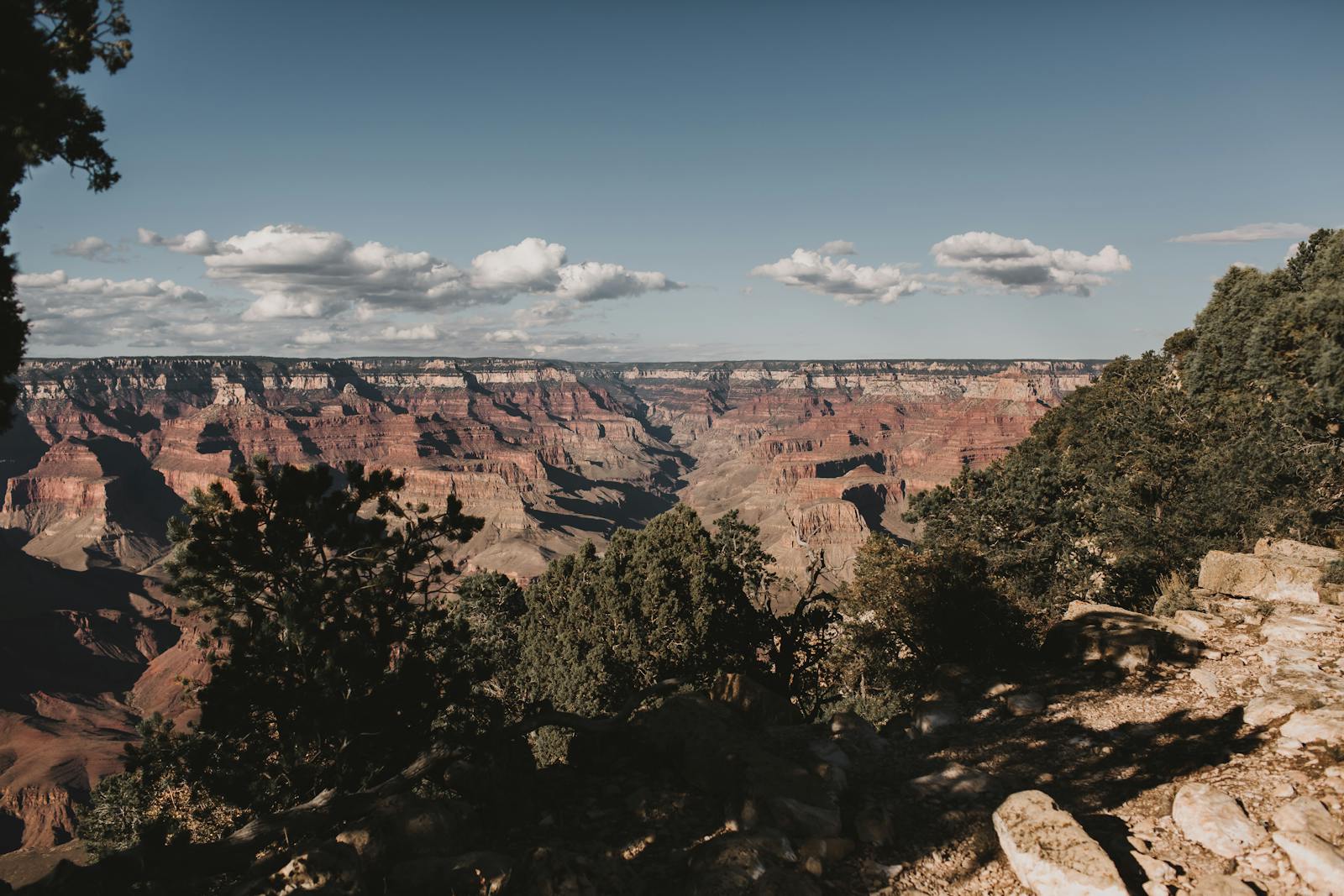 Breathtaking view of the Grand Canyon with blue skies and dramatic rock formations.
