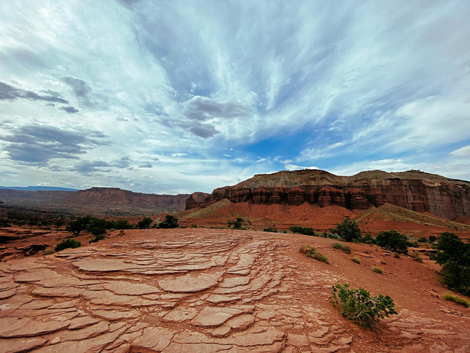 Expansive view of the rugged red rocks and dramatic clouds over Capitol Reef National Park in Utah.