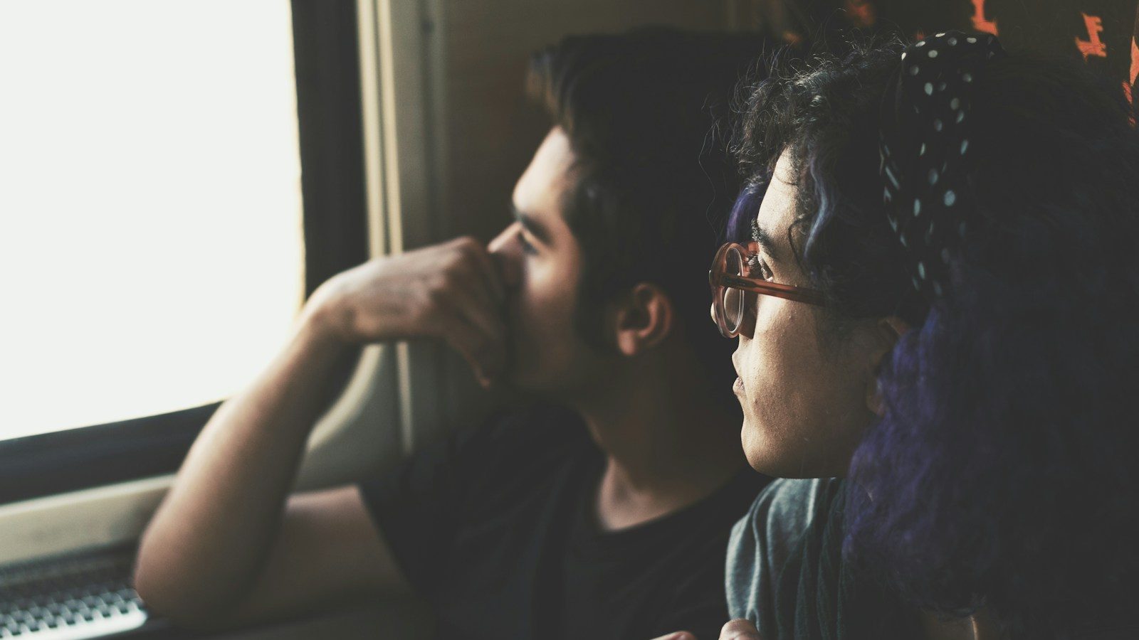 two man and woman look at the window