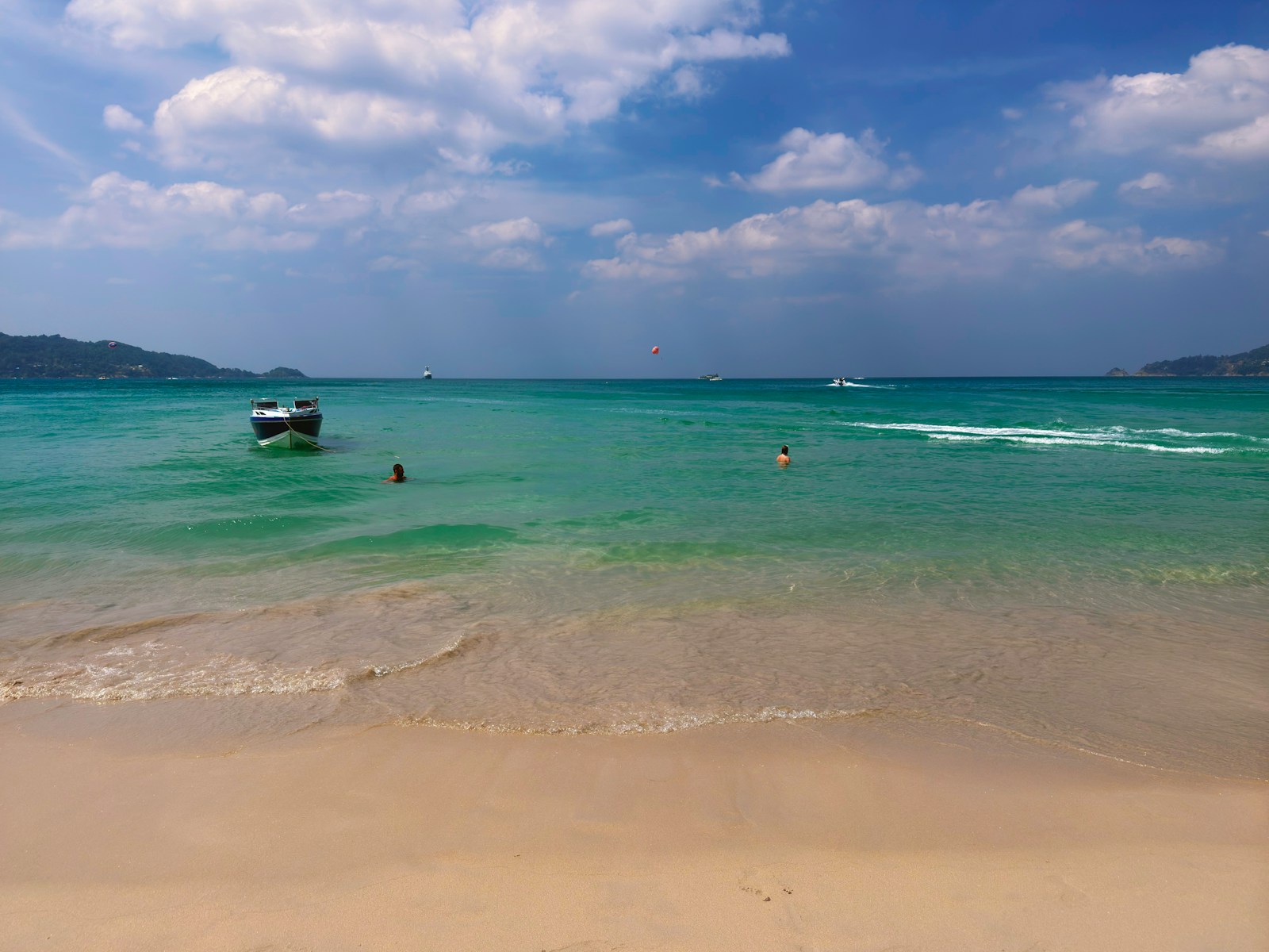 A beach with a boat in the water