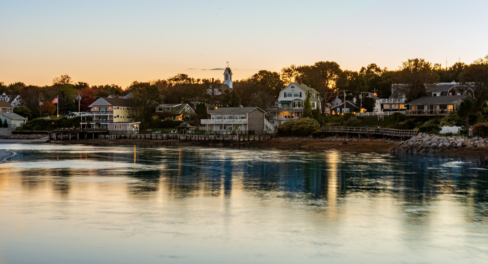 a body of water with houses in the background