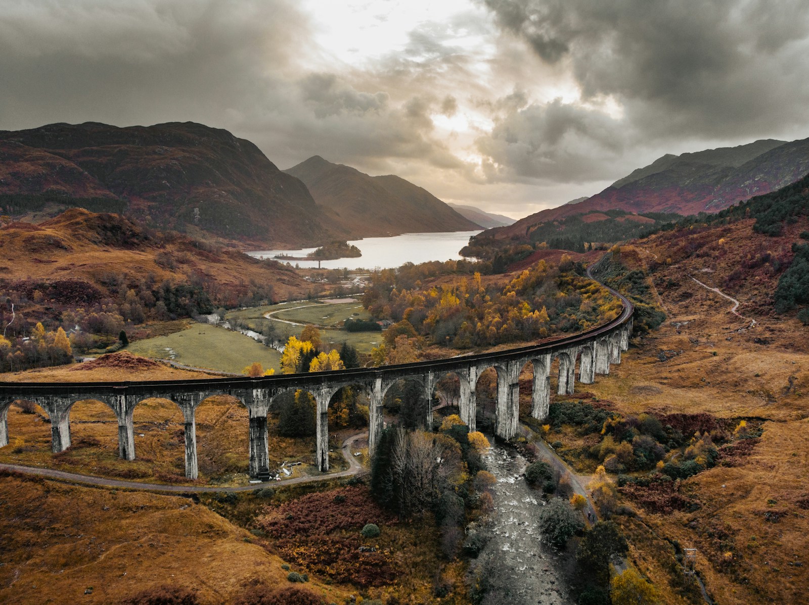 a train traveling over a bridge over a river