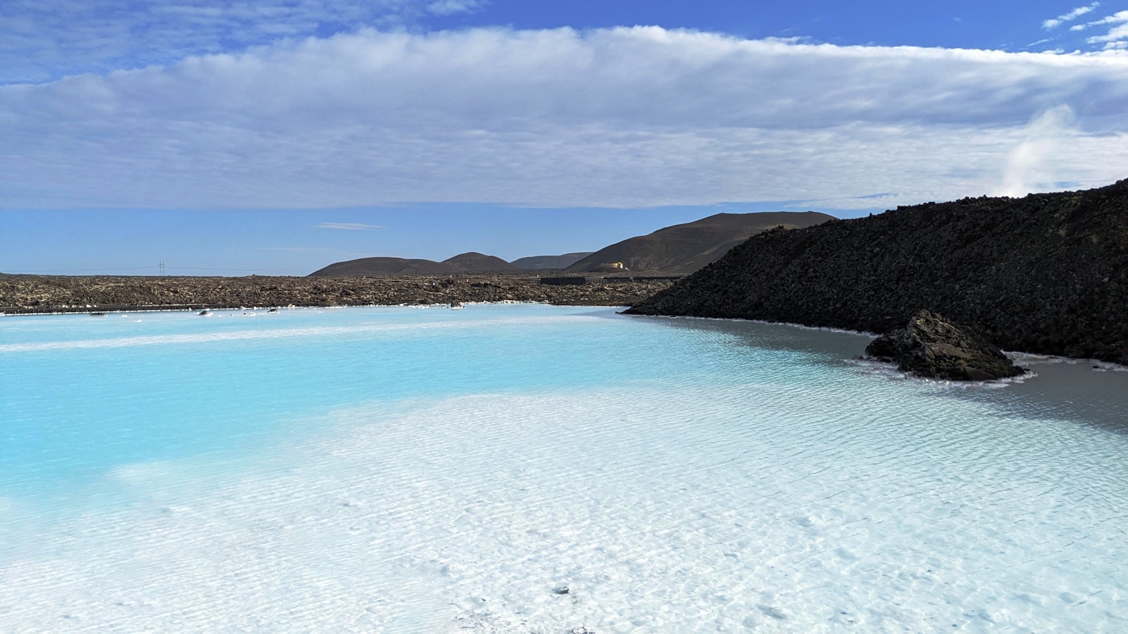 a body of water with hills in the background