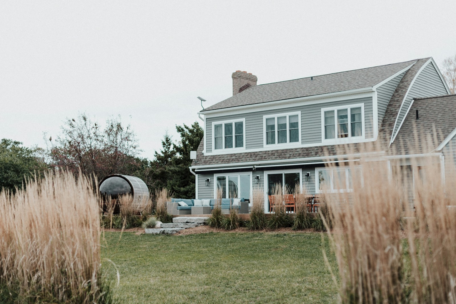 A large house sitting next to a lush green field