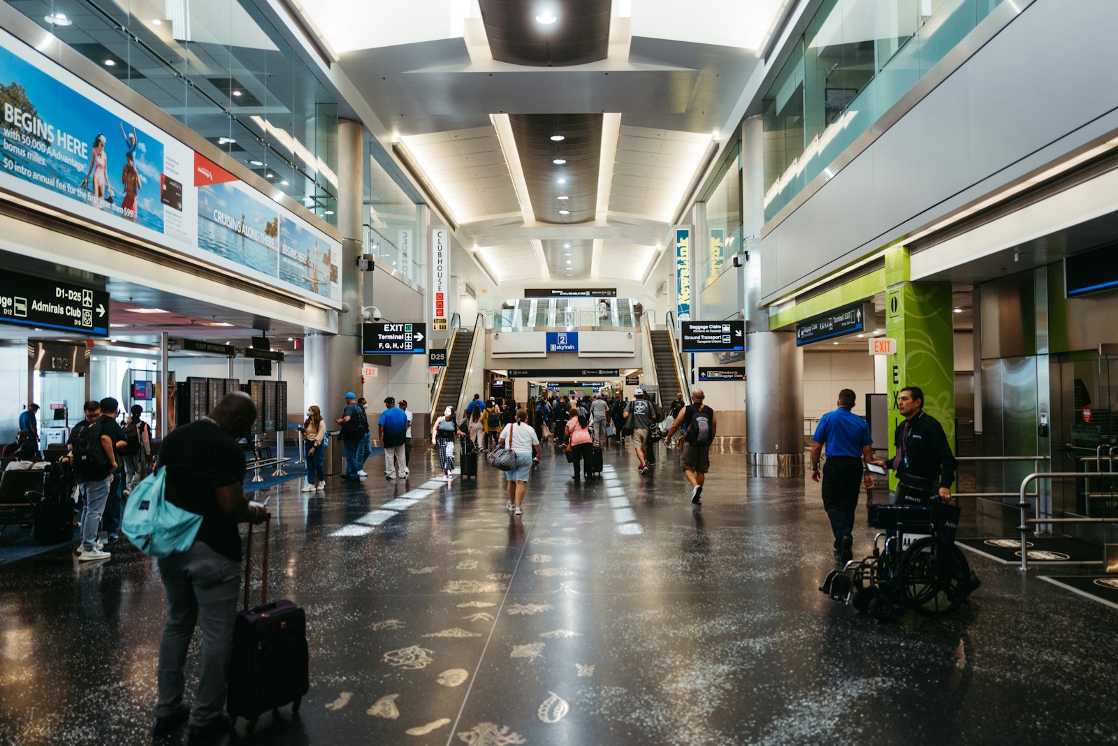 a group of people walking through an airport