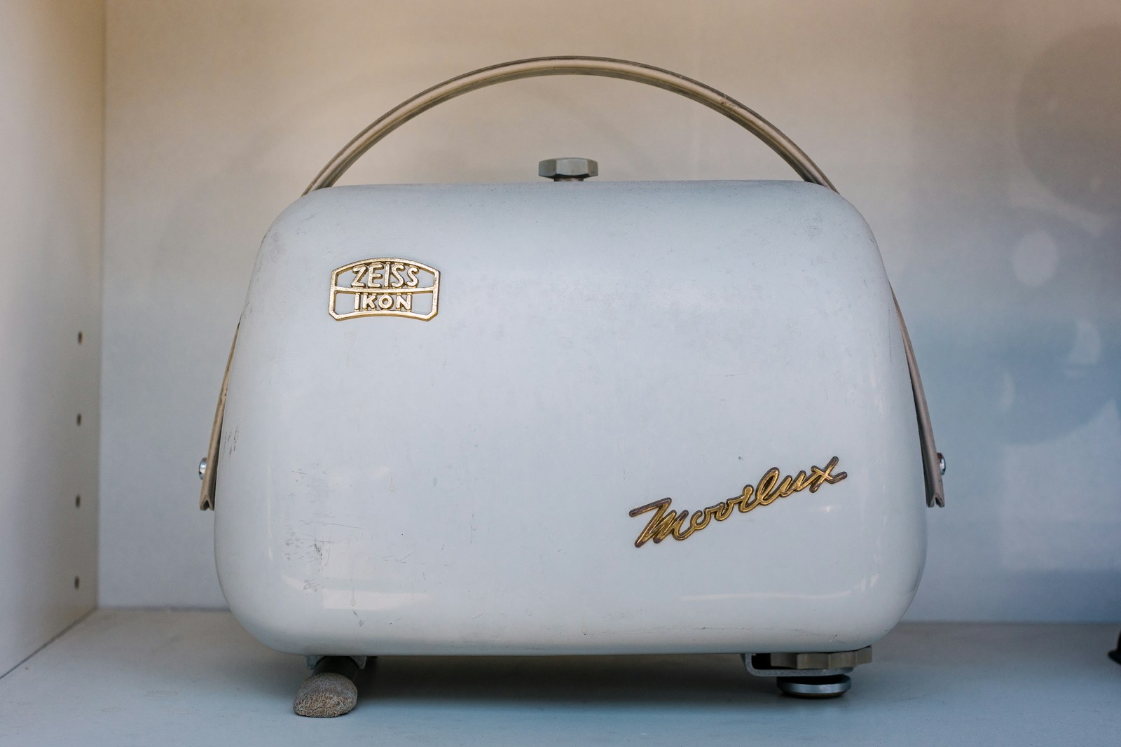 a white toaster sitting on top of a white counter