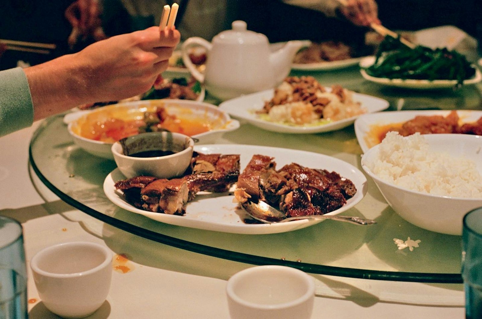 A group of people sitting around a table with plates of food