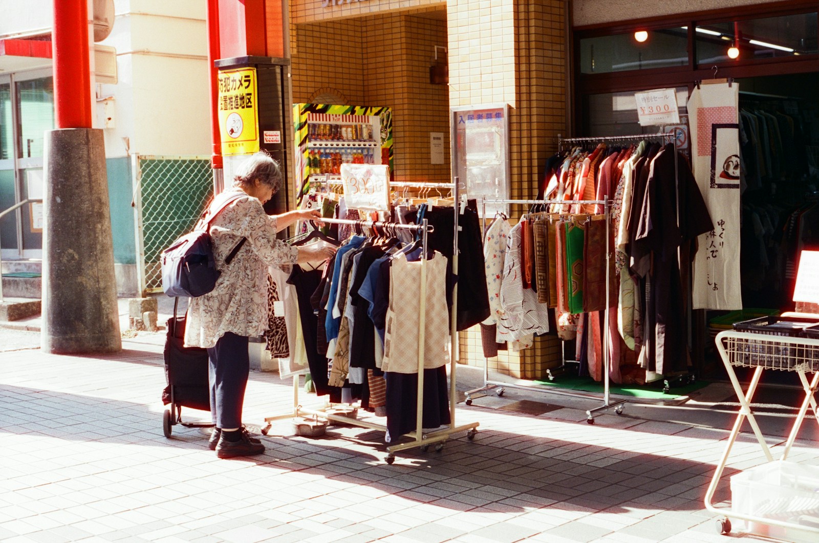 A woman standing in front of a clothing store
