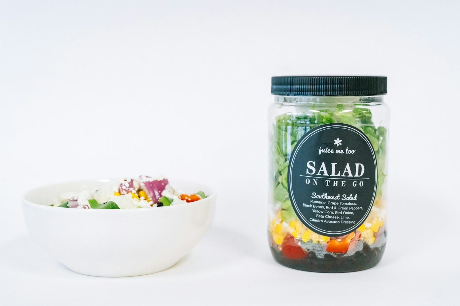 A salad-in-a-jar and a bowl of salad.