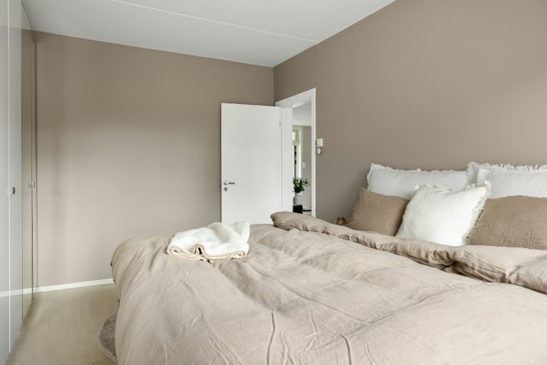 A bedroom with a bed and a closet