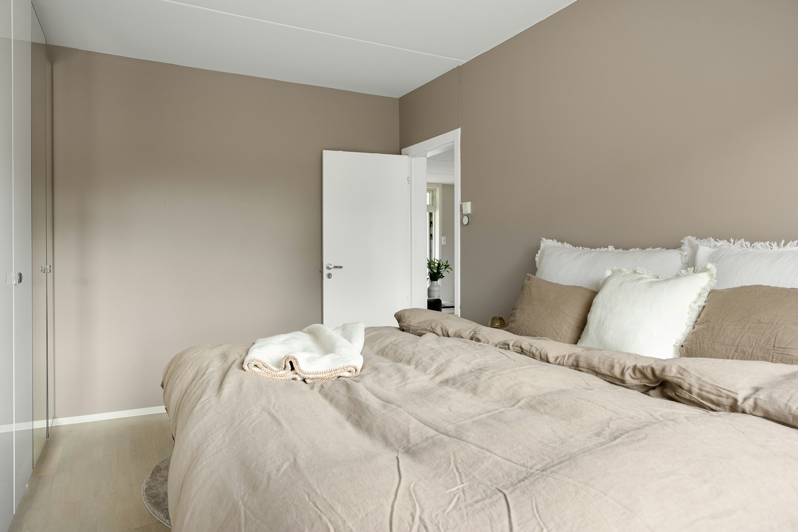 A bedroom with a bed and a closet