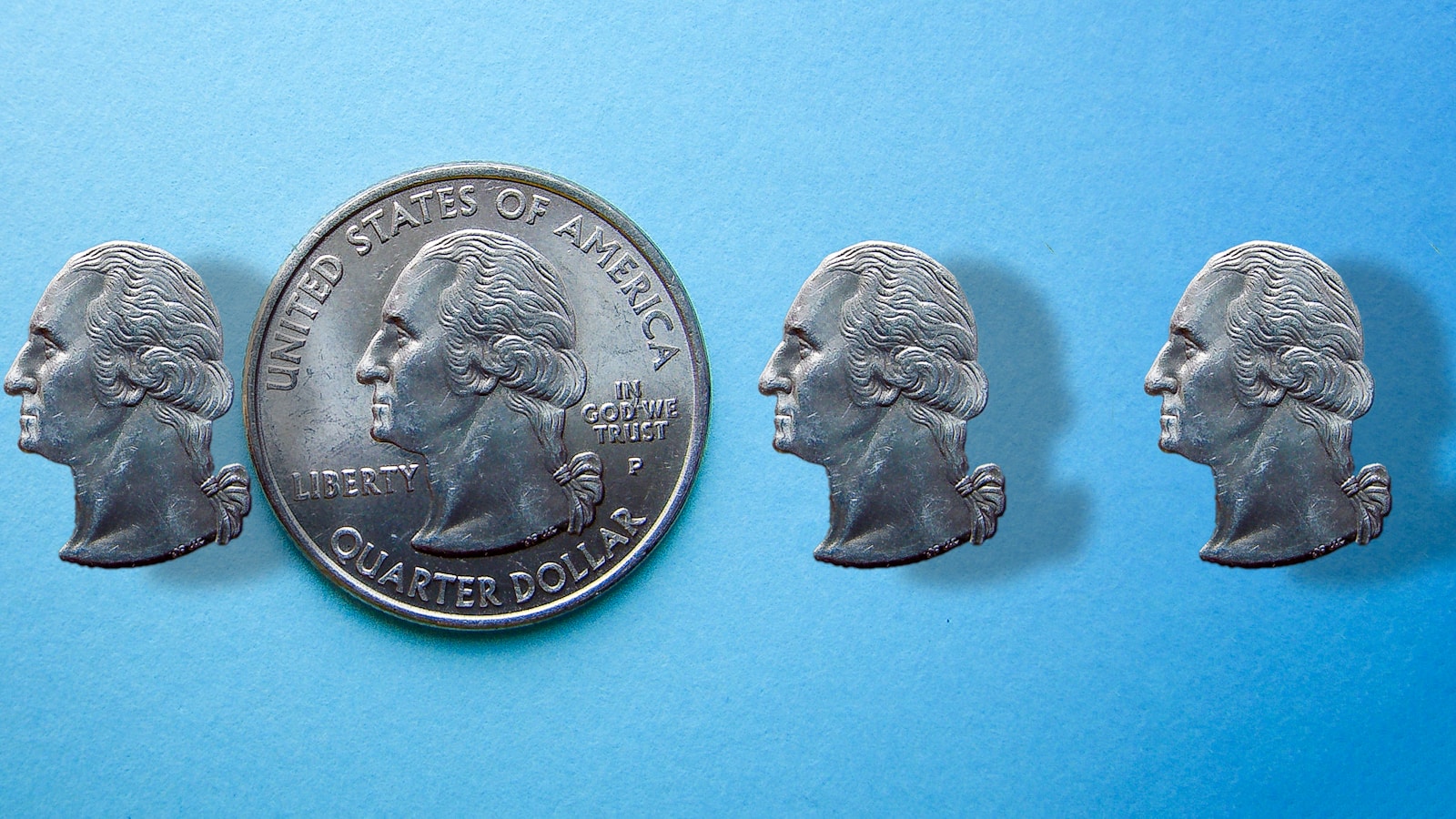 A penny with five heads of people on it