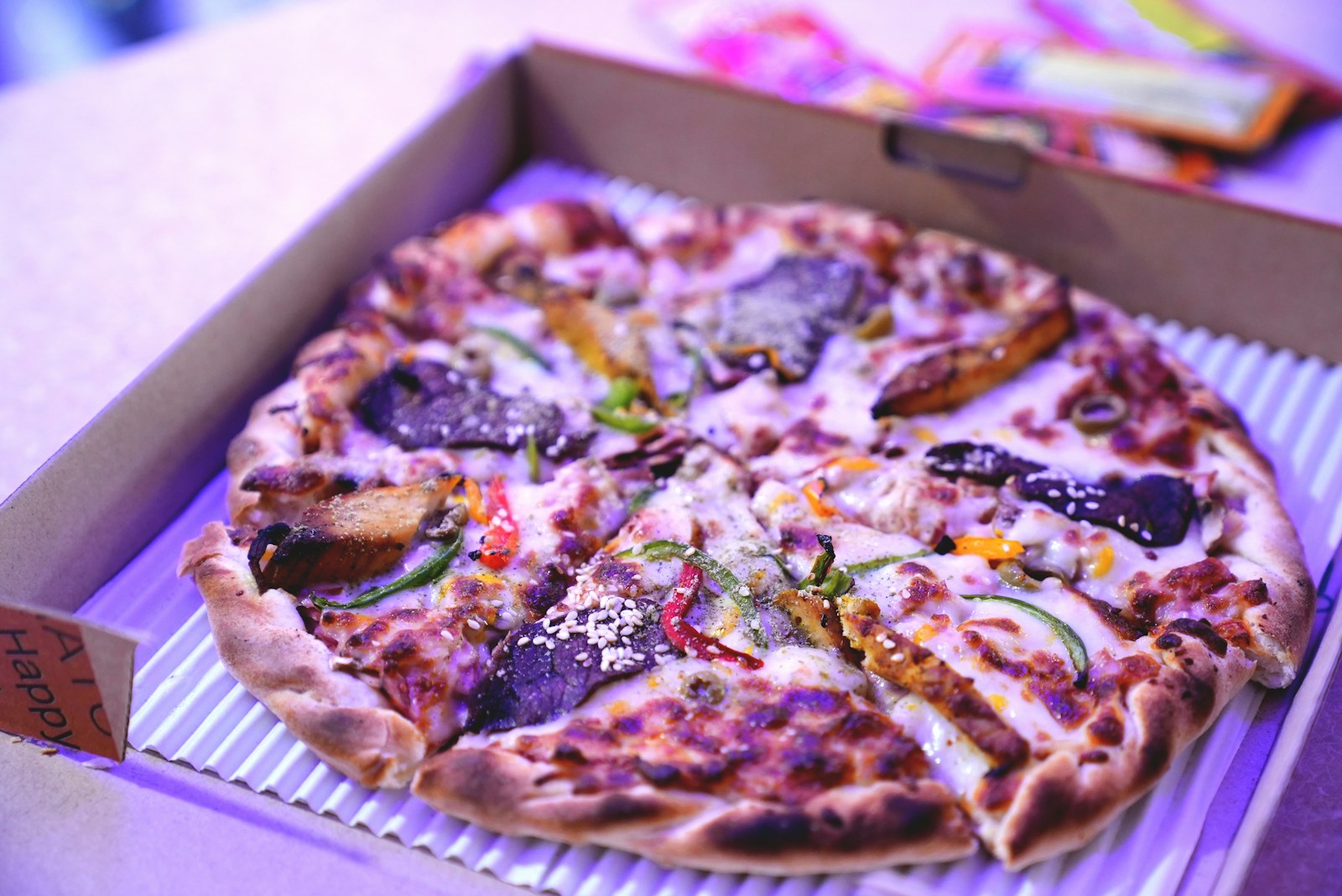 a pizza sitting in a box on top of a table