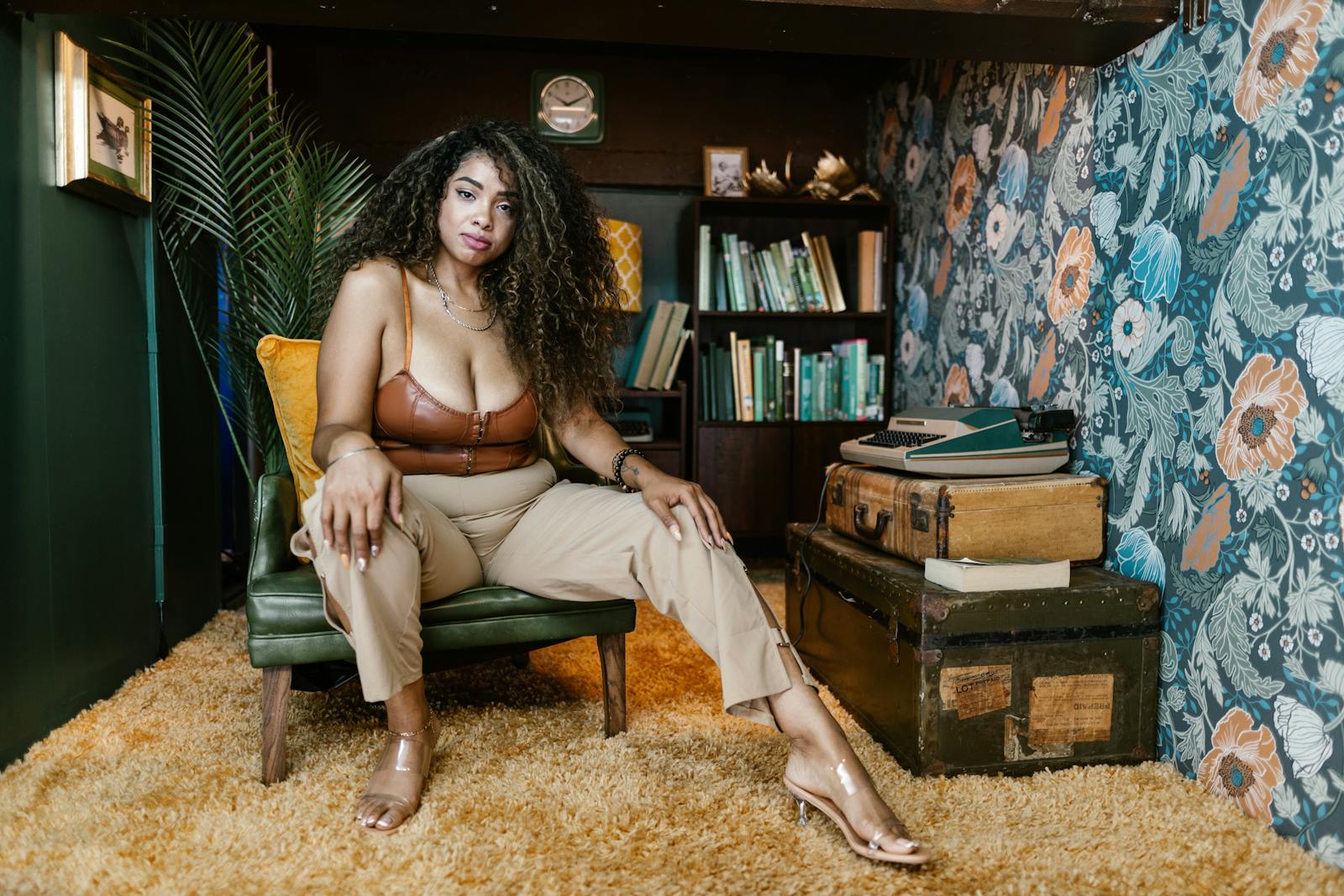 Confident plus-size woman posing in a retro-themed living room.