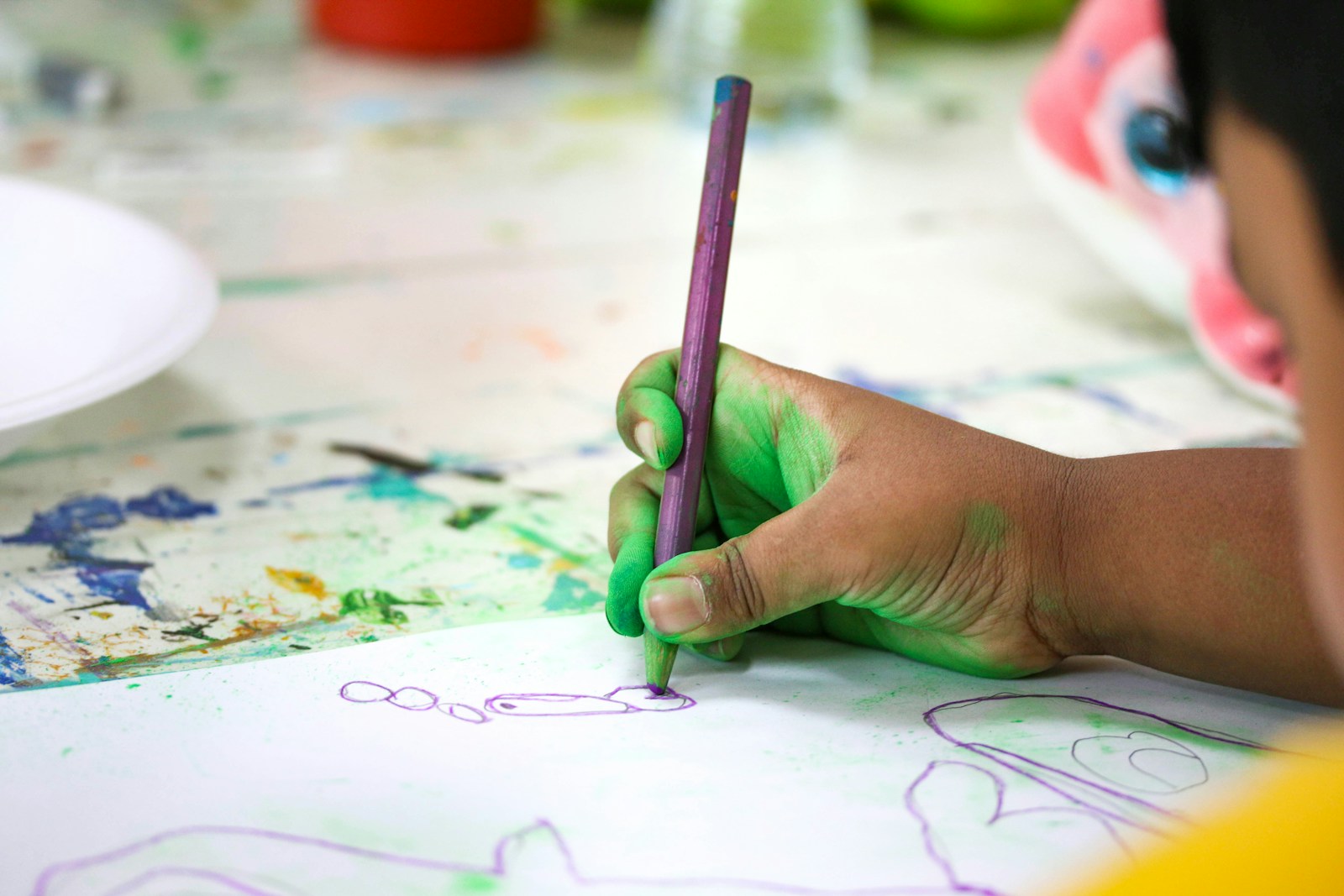 a child drawing on a paper