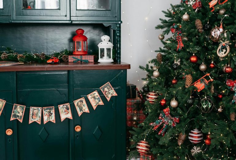 Cozy Christmas scene with decorated tree, lanterns, and vintage cards.