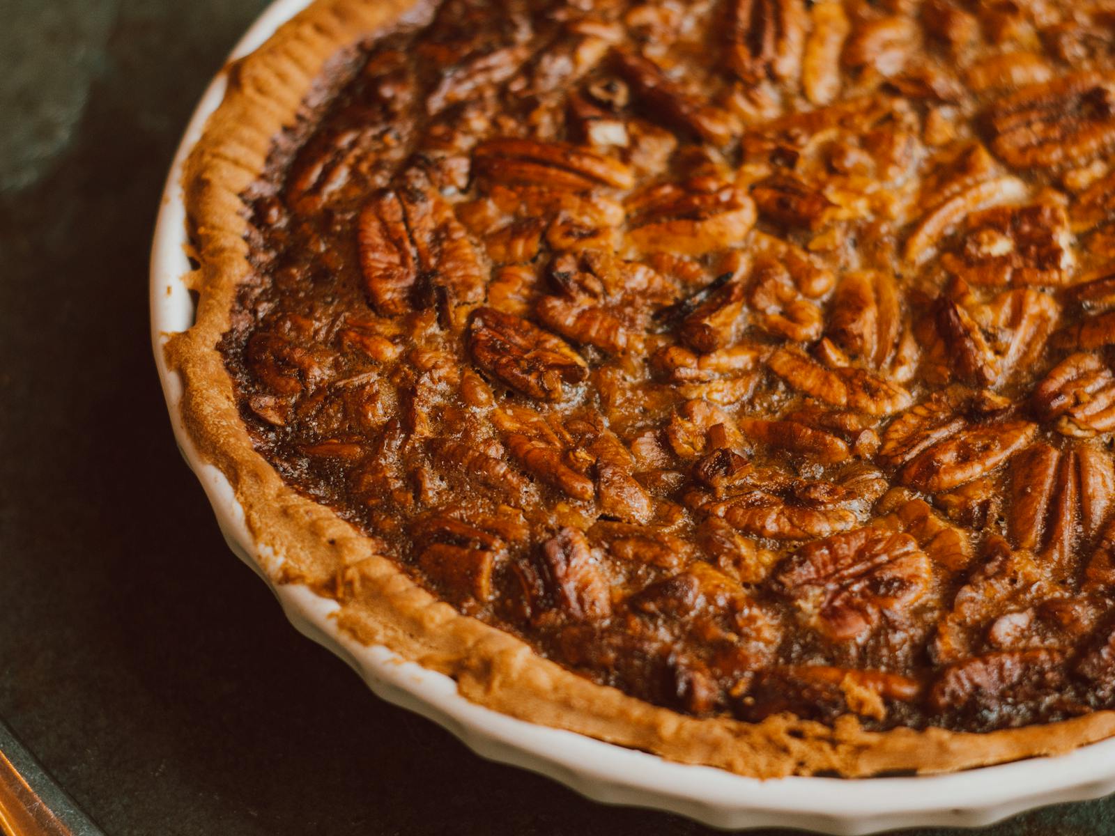 Delicious homemade pecan pie with golden crust captured in a close-up for food lovers.