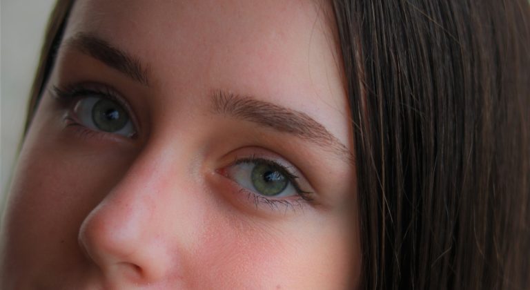 womans face with brown eyes