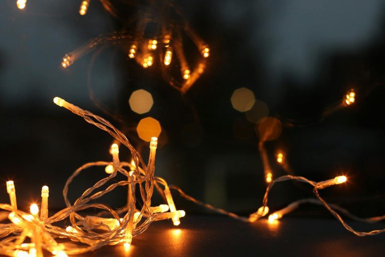 Close-up of glowing string lights creating a cozy ambiance with warm bokeh background.