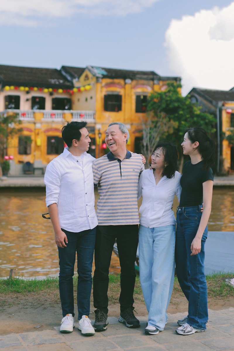 A family poses together in front of colorful buildings.