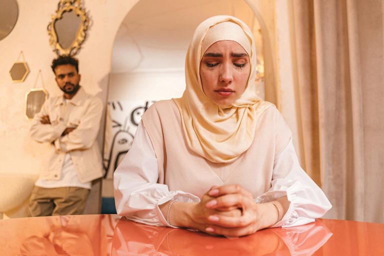 Young couple experiencing relationship tension, woman deeply upset indoors.