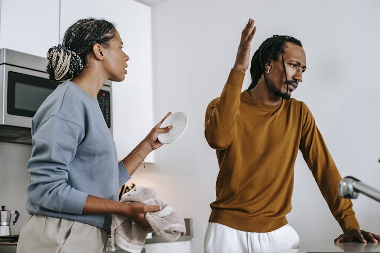 An intense discussion between a couple in a modern kitchen setting.