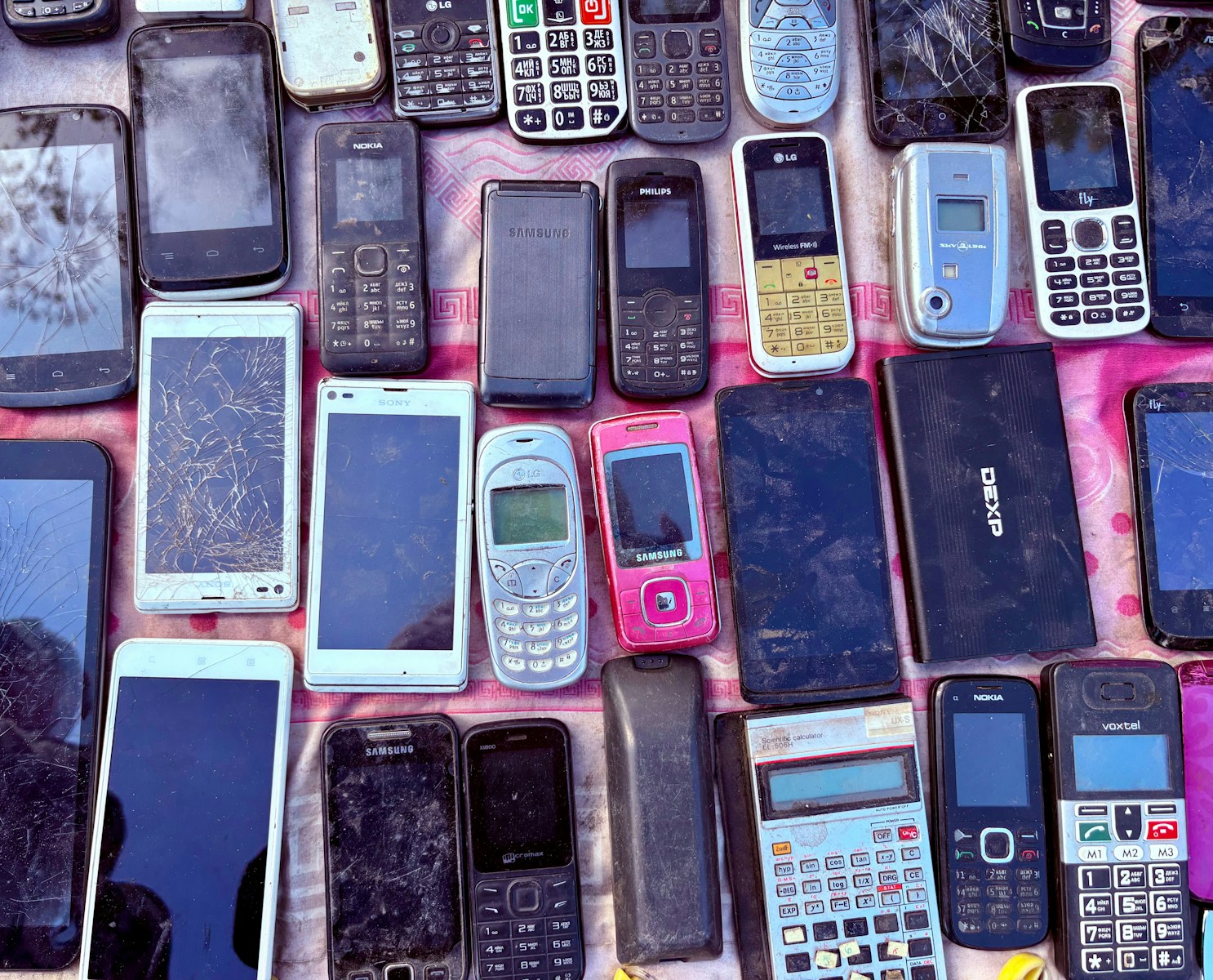 A collection of various old mobile phones and devices.