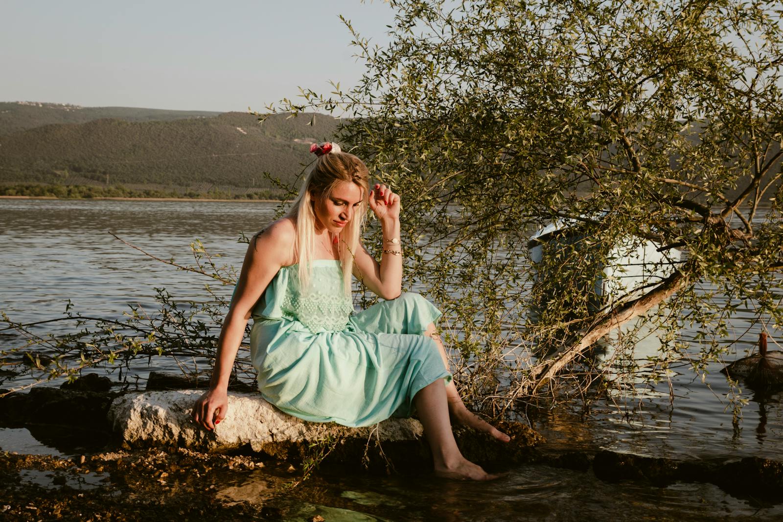 Serene moment by the lake in Bursa, Türkiye, with a woman in a pastel dress.