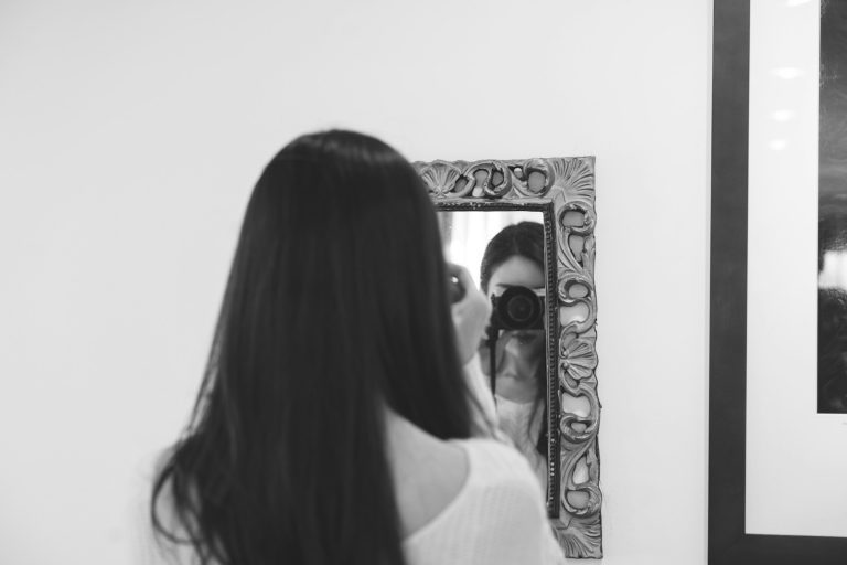 woman in white shirt taking self portrait