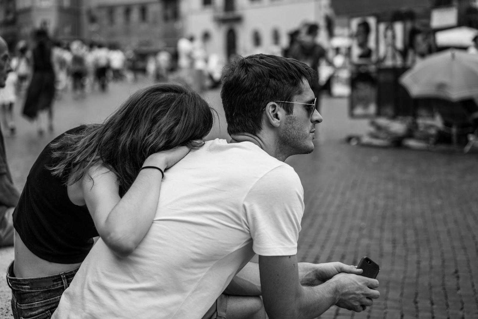 a man and a woman sitting on the ground