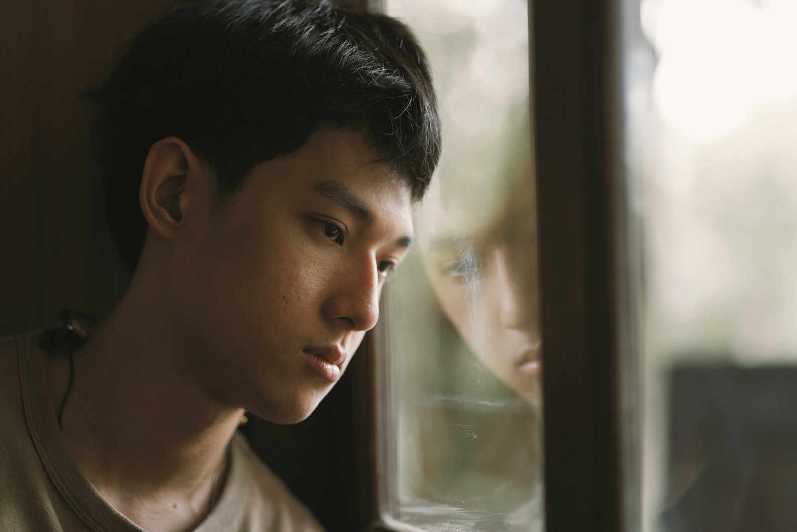 a man looking out of a window at another person