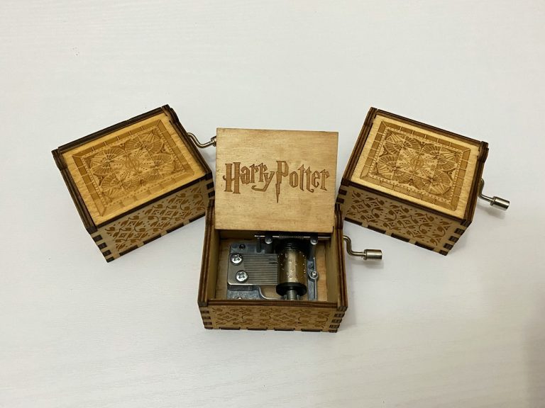 brown wooden box with silver and black camera