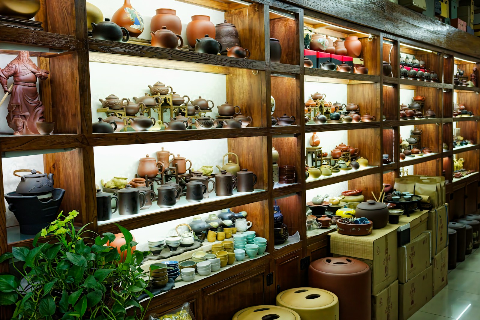 A room filled with lots of shelves filled with vases